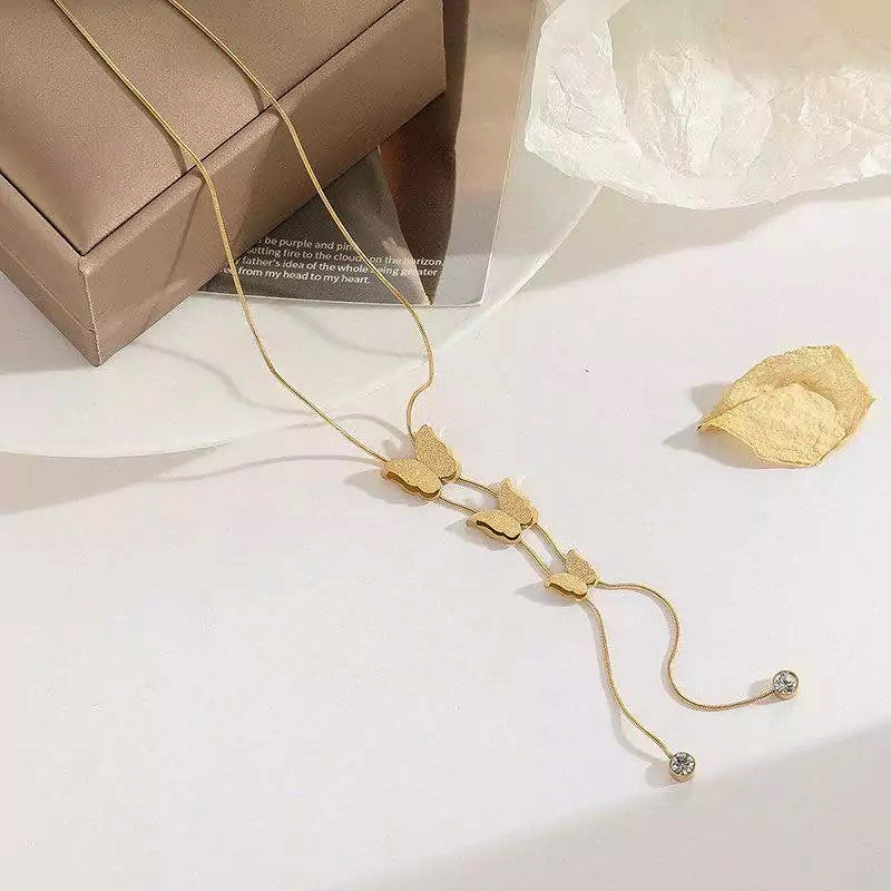 Elegant stainless steel butterfly necklace for women featuring detailed butterfly charms, offered by Tarjah Mart.