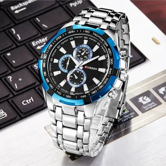 Silver and blue Curren 8023 men's watch with a round dial and metal band, showcasing a stylish and modern design.