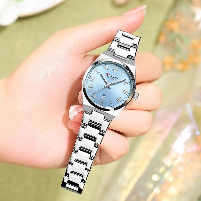 Silver and blue stainless steel women's watch by Curren with a round dial and elegant design.