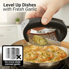 Stainless steel garlic crusher by Tarjah Mart, showing the textured crushing chamber and ergonomic handle for kitchen use.