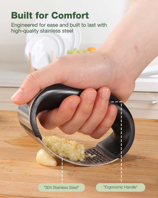 Stainless steel garlic crusher from Tarjah Mart with ergonomic handle and mesh chamber for easy garlic mincing in the kitchen.