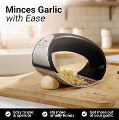 Stainless steel garlic crusher kitchen tool by Tarjah Mart, with textured handles and a chamber for crushing garlic cloves.
