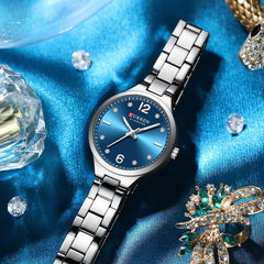 Women's stainless steel watch by Curren, model 9105, featuring a sleek design and round dial with a silver finish.