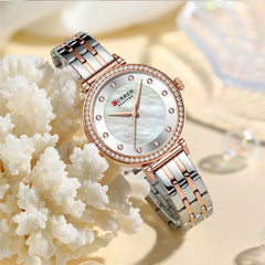Close-up of Curren 9087 women's stainless steel watch with a sleek silver band and round dial.