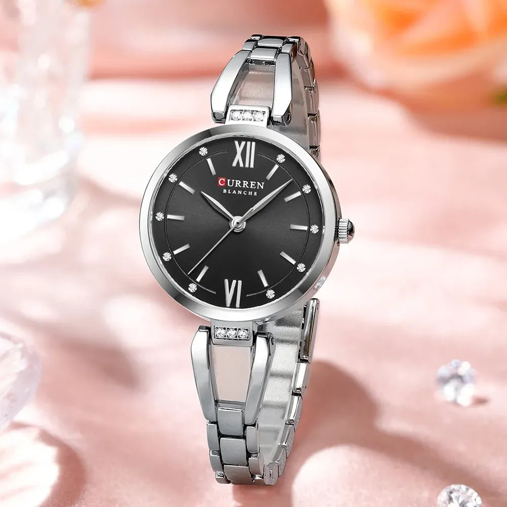 Elegant ladies' Curren 9092 stainless steel watch with a black and silver design and a light blue dial.