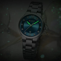 Curren 9107 women’s quartz luxury stainless steel watch with white dial, elegant design, and silver strap.