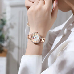 Elegant Curren 9087 women's stainless steel watch with a sleek design and silver tone, featuring a round dial and bracelet strap.