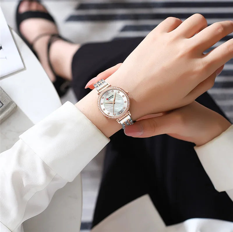 Elegant Curren 9087 women's stainless steel watch with a sleek silver design and round dial.