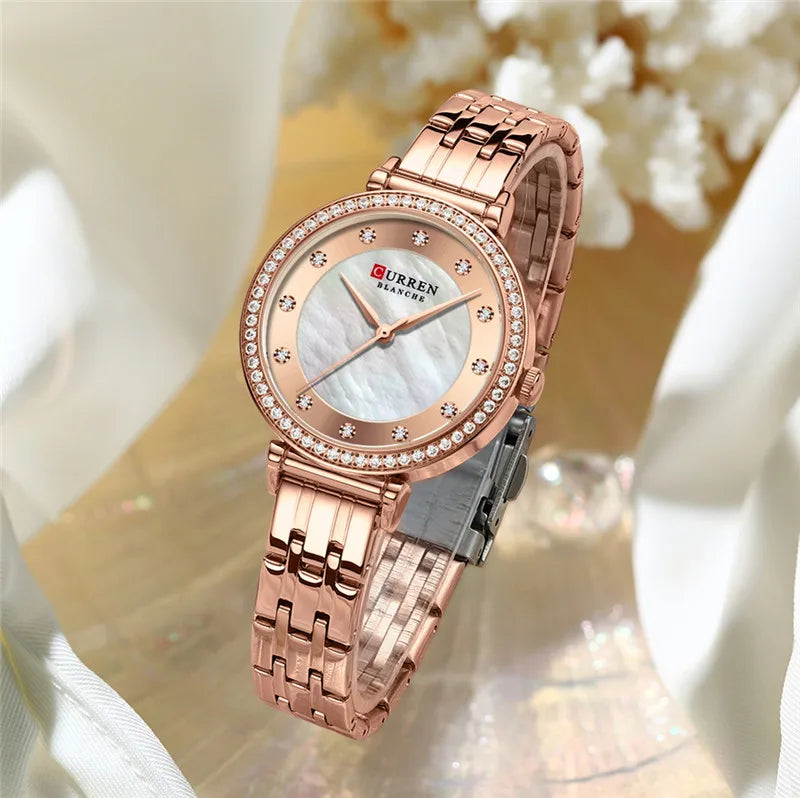 Stainless steel women's watch from Curren 9087 with a sleek silver band and round dial, displayed on a white background.