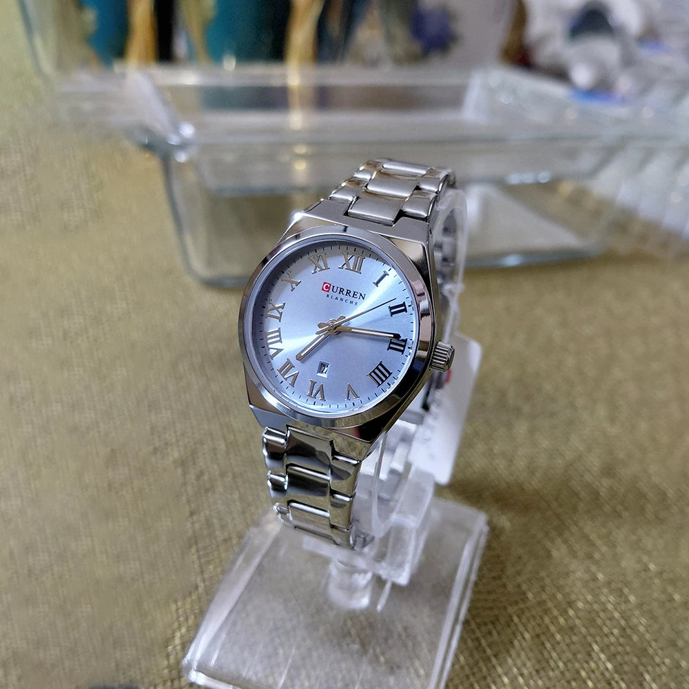 Silver and blue stainless steel women's Curren 9095 watch with a sleek round face and elegant design.