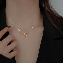 Stainless steel double love necklace from Tarjah Mart featuring two linked heart pendants on a delicate chain.