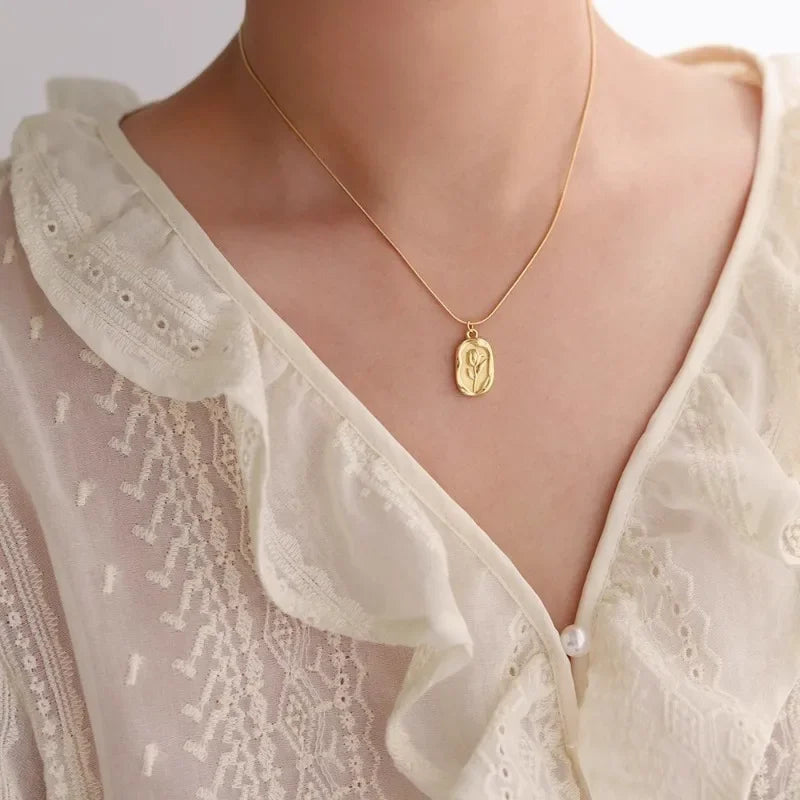 Vintage geometric rose pendant necklace by Tarjah Mart featuring a simple, elegant floral design on a delicate chain.