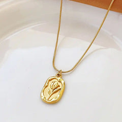 Vintage geometric rose pendant necklace by Tarjah Mart featuring a simple, elegant design with a floral motif on a delicate chain.