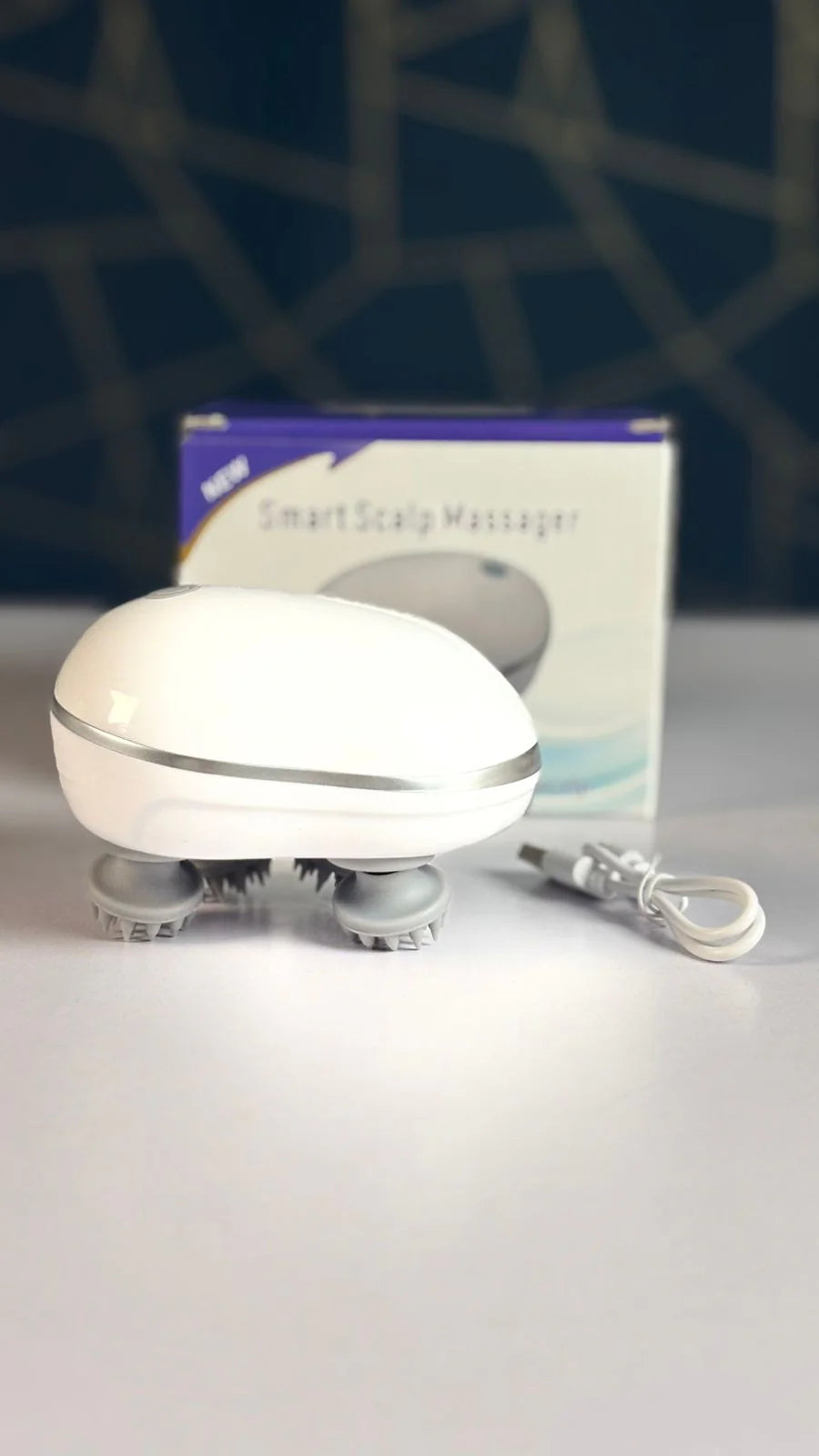 Electronic scalp massager OSK-701 by Tarjah Mart showing its ergonomic design and multiple massage nodes for relaxing scalp therapy.