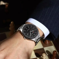 Silver and black Curren men's quartz watch with a sleek design, featuring a round dial and metal strap.