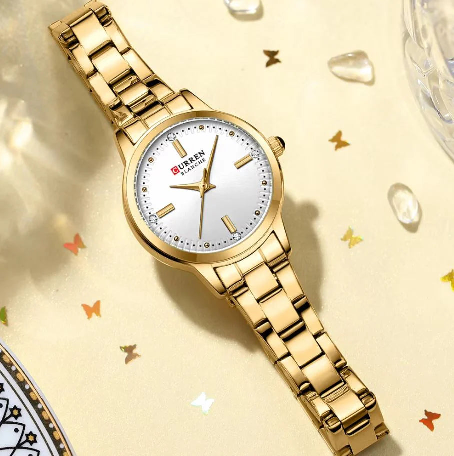 Curren 9094 women's luxury stainless steel watch with green and gold accents, featuring a sleek design and gold-tone dial.