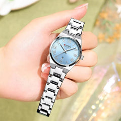 Silver and blue stainless steel women's watch by Curren with a round dial and elegant design.