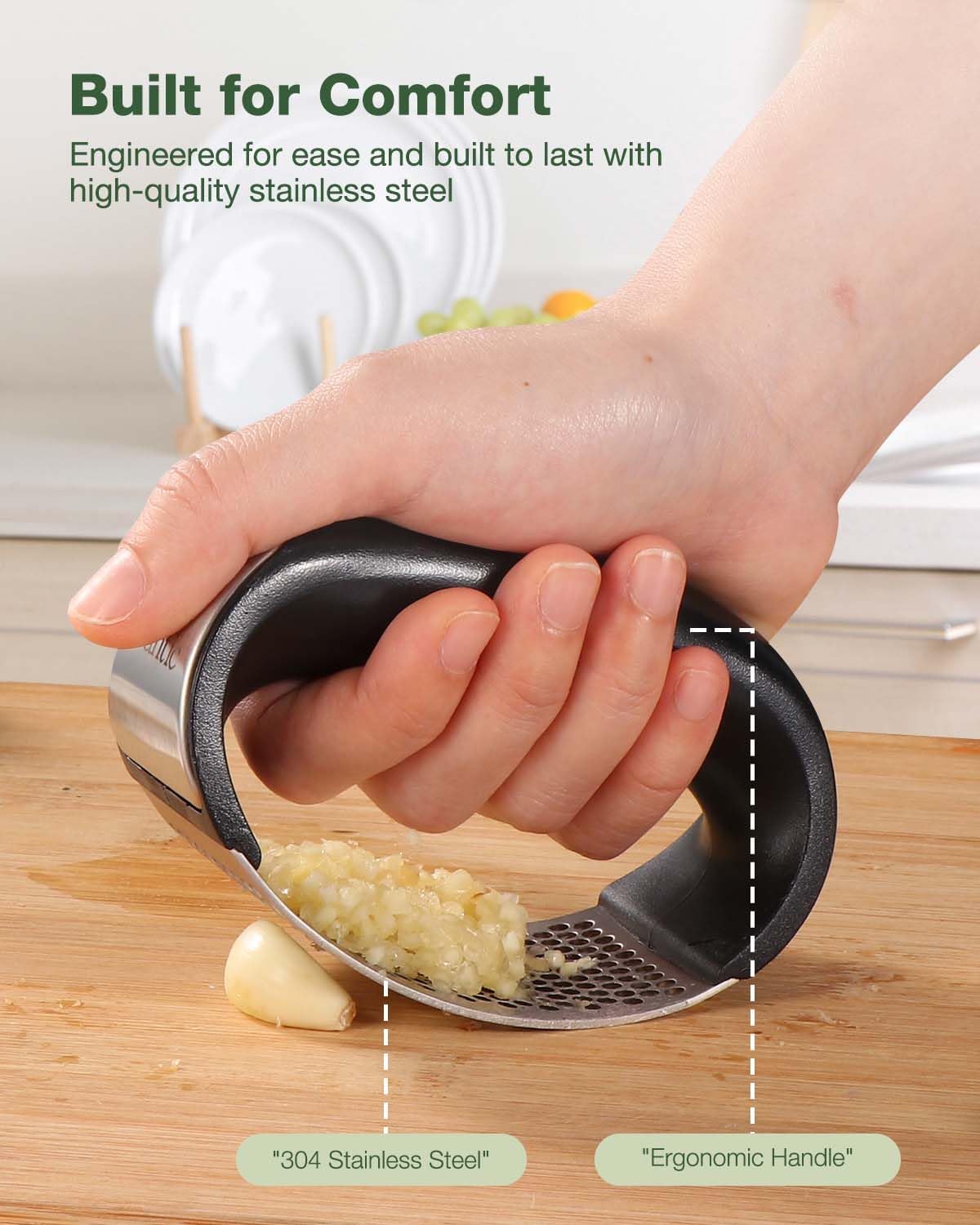Stainless steel garlic crusher from Tarjah Mart with ergonomic handle and mesh chamber for easy garlic mincing in the kitchen.
