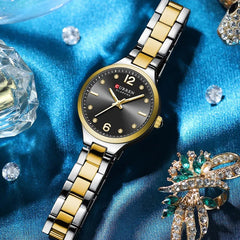 Close-up of Curren 9105 women's stainless steel watch with round dial and silver band, showcasing elegant design and craftsmanship.