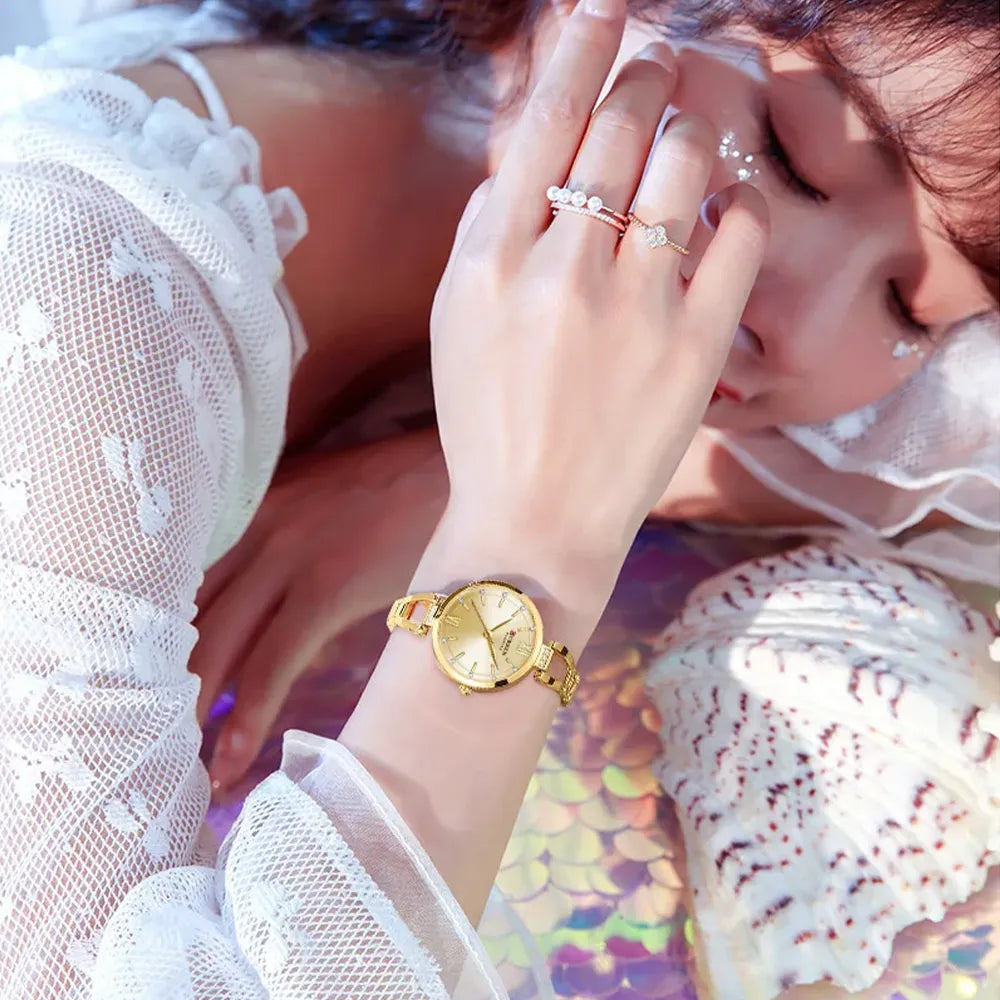 Elegant Curren 9092 women's luxury stainless steel watch with a light blue dial and gold-tone finish, showcasing a sophisticated design.