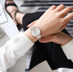 Elegant Curren 9087 women's stainless steel watch with a sleek silver design and round dial.