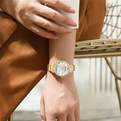 Women's Curren 9087 stainless steel watch with a sleek design and round face, featuring a silver-tone band.