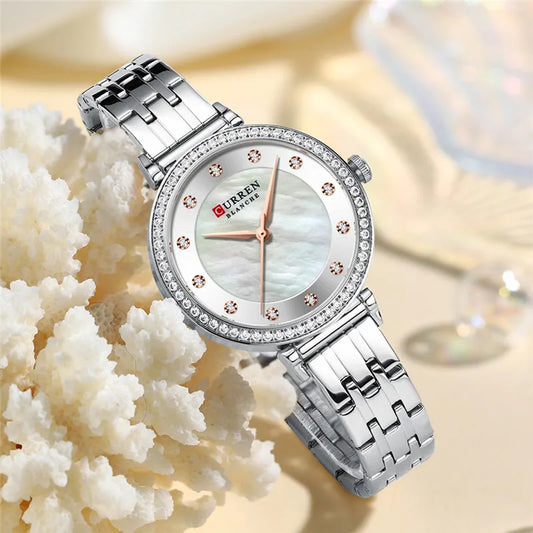Curren 9087 women's stainless steel watch with a sleek design, featuring a round dial and silver-tone band.