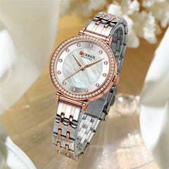 Curren 9087 women's stainless steel watch with a sleek design, featuring a round dial and silver-tone band.