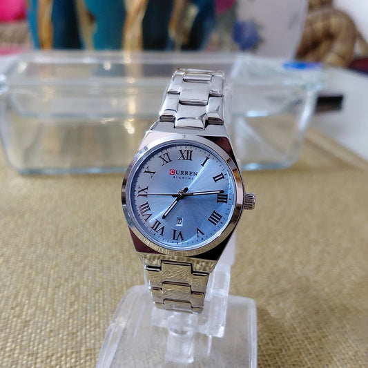 Silver and blue Curren 9095 women's stainless steel watch with a sleek design and round dial.