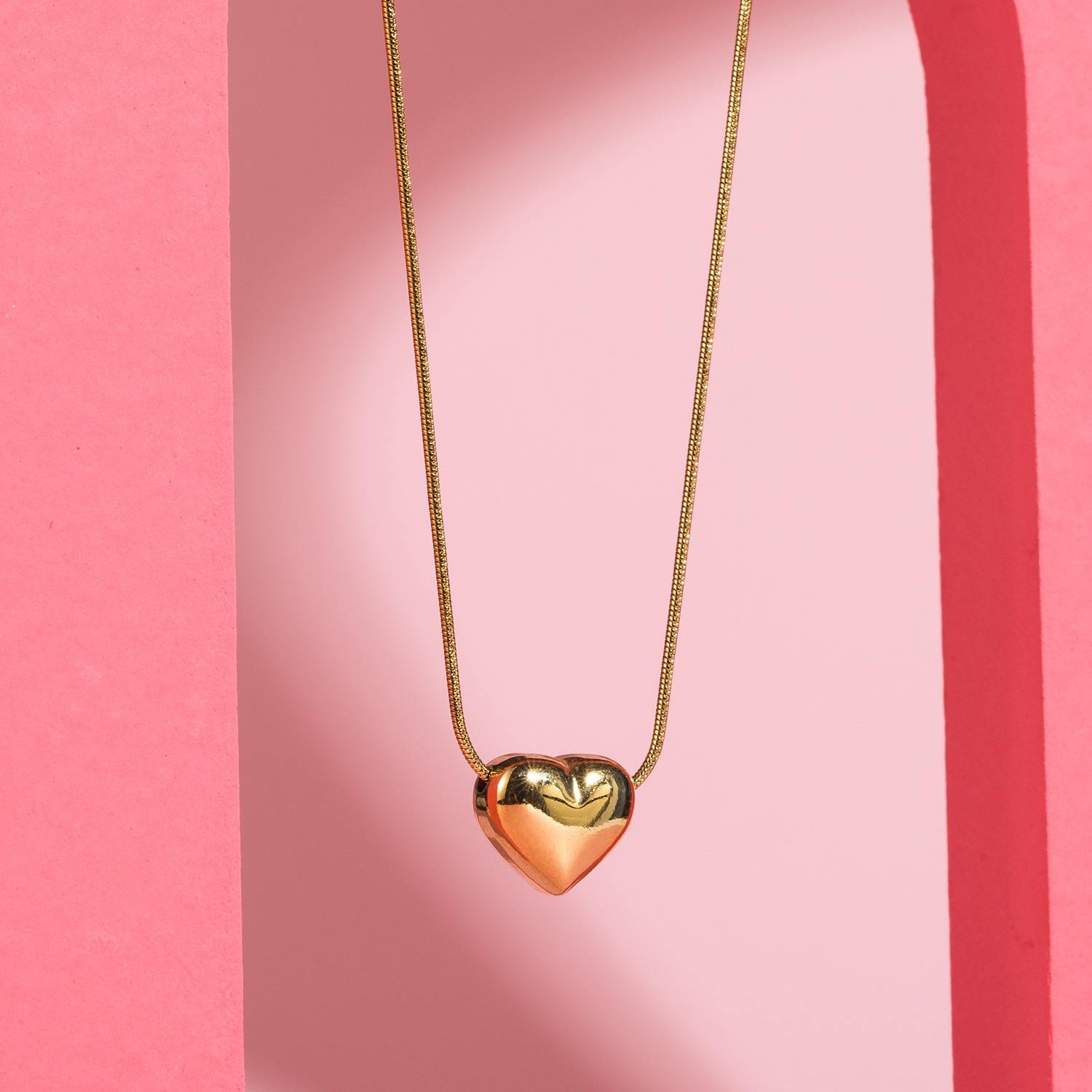 Shiny stainless steel face love necklace by Tarjah Mart featuring a sleek, modern design with a heart-shaped pendant.