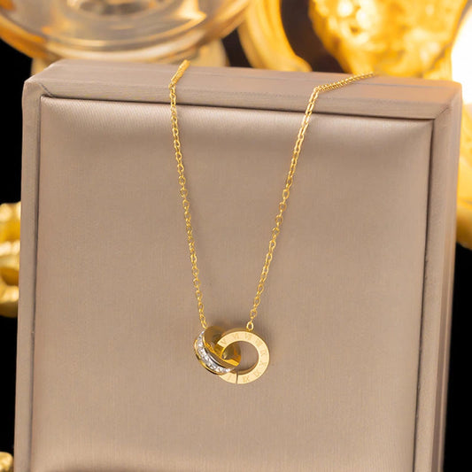 Gold Roman Double Ring Necklace by Tarjah Mart featuring two interconnected rings on a delicate chain.