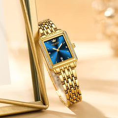 Blue OLEVS 9995 women's elegant quartz watch with a sleek round dial and stylish design.
