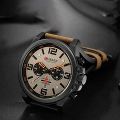 Curren 8314 men's leather strap watch showing a round dial with a black face and silver details.