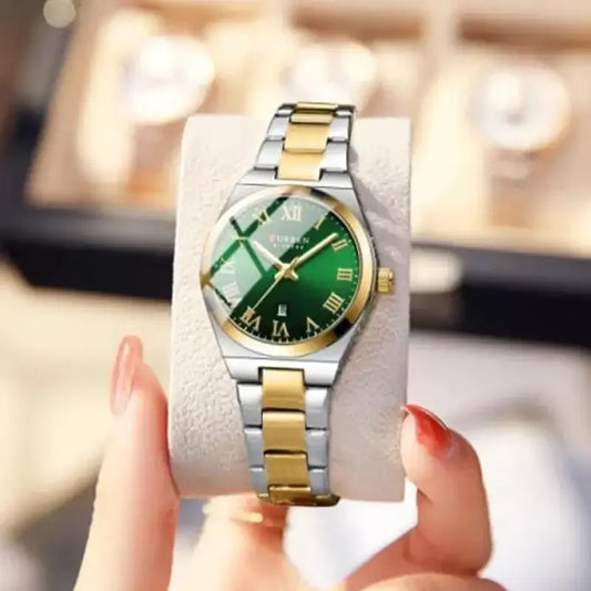 Women's Curren 9095 stainless steel watch with a green dial and band, featuring a stylish and elegant design.